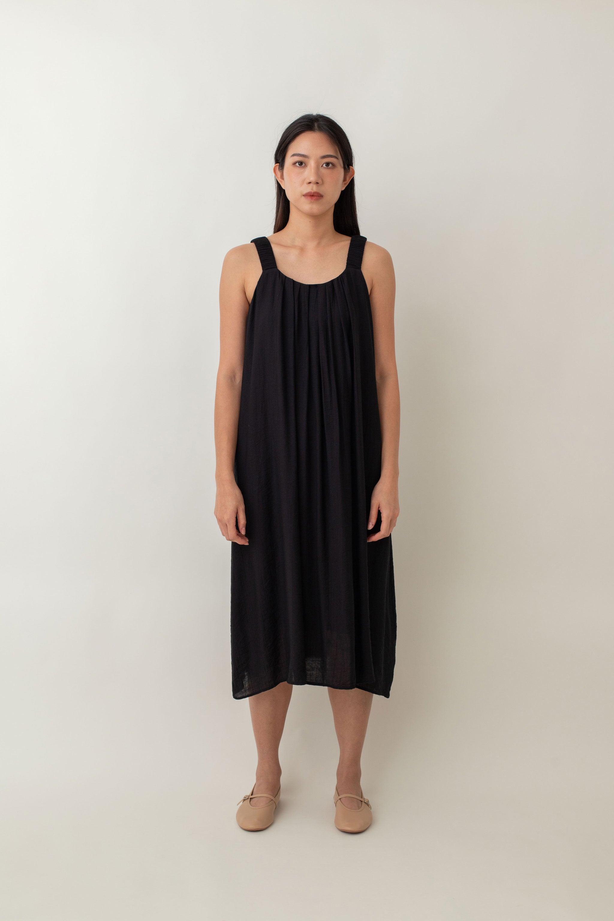 Calliope Dress features a soft, flowy fabric that drapes beautifully. The relaxed fit, coupled with delicate pleats at the neckline, creates a graceful silhouette that flatters all body types. It also comes with thoughtful details, such as side pockets, and adjustable tie detail, allowing you to customize the fit and style to your preference.&nbsp;Whether you choose to tie it at the front, back, or side, this versatile detail adds a unique touch to this dress.