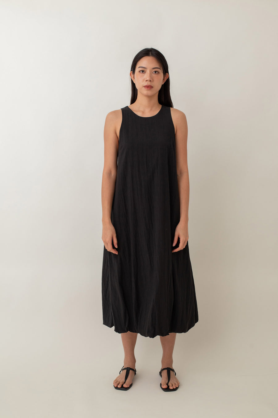 With its airy balloon silhouette that tapers gently at the hem, the Saffron Dress offers a playful and relaxed vibe. The dress has a simple sleeveless design with a round neckline and handy side pockets, perfect for stashing your essentials. The back zipper makes it easy to slip on and off, adding to its effortless appeal.