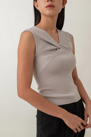 Crafted from a soft, stretchy fabric, Xanthe offers a comfortable fit that flatters your figure. The standout feature is the intricate knot detail at the front, adding a unique twist to a classic design. Pair it with high-waisted skirts or tailored pants for a chic, polished look, or dress it down with jeans for a stylish yet casual outfit.