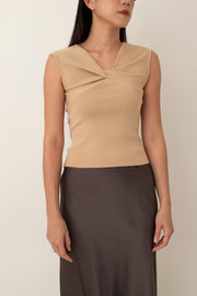 Crafted from a soft, stretchy fabric, Xanthe offers a comfortable fit that flatters your figure. The standout feature is the intricate knot detail at the front, adding a unique twist to a classic design.&nbsp;Pair it with high-waisted skirts or tailored pants for a chic, polished look, or dress it down with jeans for a stylish yet casual outfit.