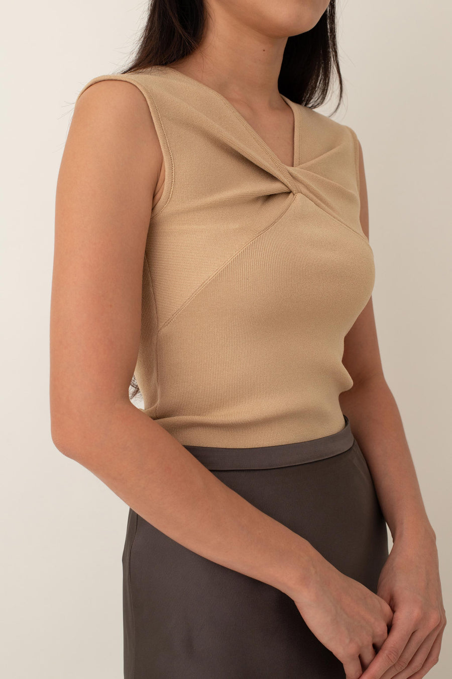 Crafted from a soft, stretchy fabric, Xanthe offers a comfortable fit that flatters your figure. The standout feature is the intricate knot detail at the front, adding a unique twist to a classic design.&nbsp;Pair it with high-waisted skirts or tailored pants for a chic, polished look, or dress it down with jeans for a stylish yet casual outfit.