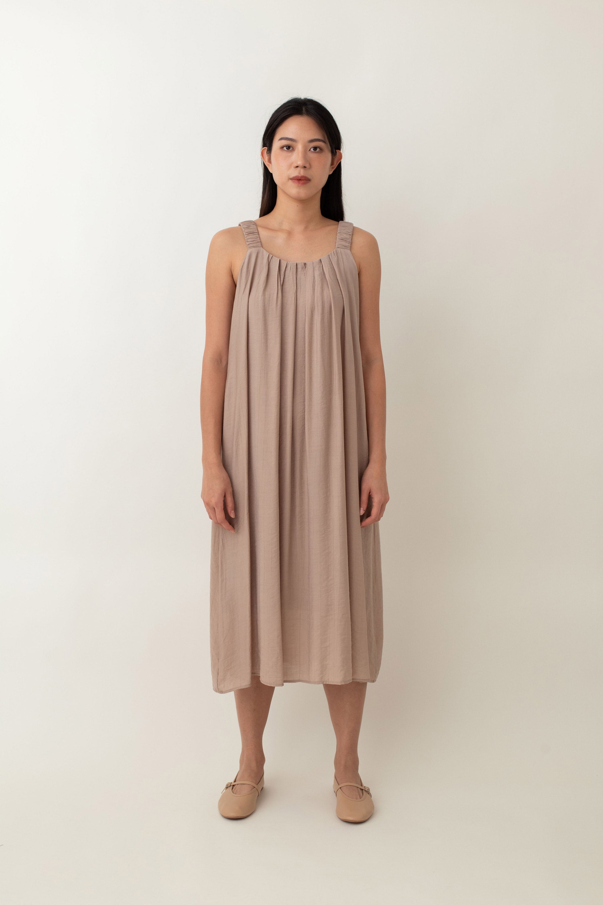 Calliope features a soft, flowy fabric that drapes beautifully. The relaxed fit, coupled with delicate pleats at the neckline, creates a graceful silhouette that flatters all body types. It also comes with thoughtful details, such as side pockets, and adjustable tie detail, allowing you to customize the fit and style to your preference.&nbsp;Whether you choose to tie it at the front, back, or side, this versatile detail adds a unique touch to this dress.