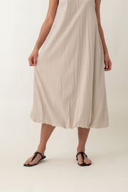 With its airy balloon silhouette that tapers gently at the hem, the Saffron Dress offers a playful and relaxed vibe. The dress has a simple sleeveless design with a round neckline and handy side pockets, perfect for stashing your essentials. The back zipper makes it easy to slip on and off, adding to its effortless appeal.