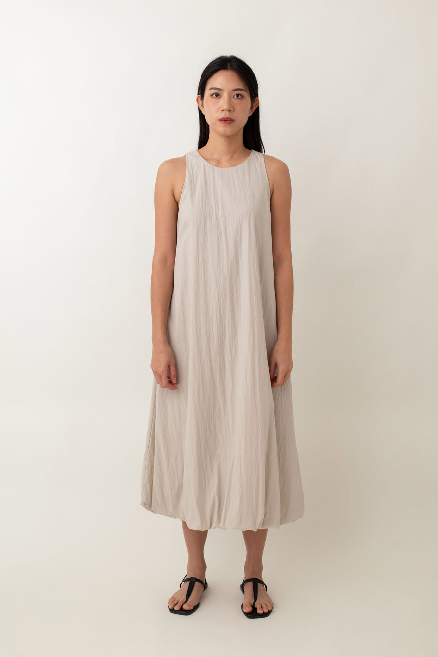 With its airy balloon silhouette that tapers gently at the hem, the Saffron Dress offers a playful and relaxed vibe. The dress has a simple sleeveless design with a round neckline and handy side pockets, perfect for stashing your essentials. The back zipper makes it easy to slip on and off, adding to its effortless appeal.