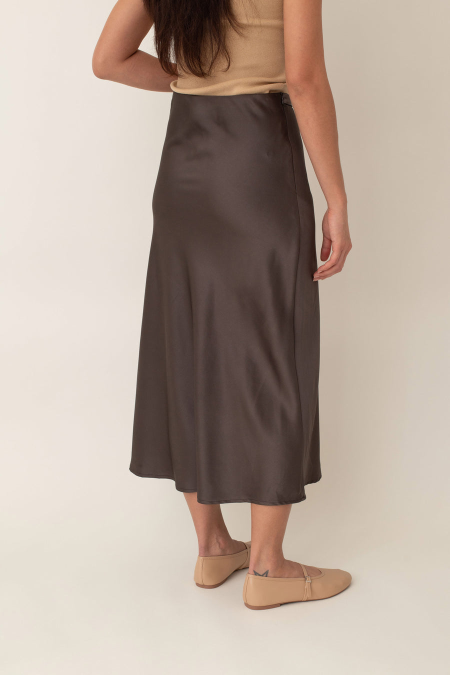 Crafted from silky fabric that feels smooth to the touch and features a subtle, beautiful sheen, the Thalia skirt flares gently from the waist. This design creates a flattering, flowy silhouette that moves gracefully with you.
