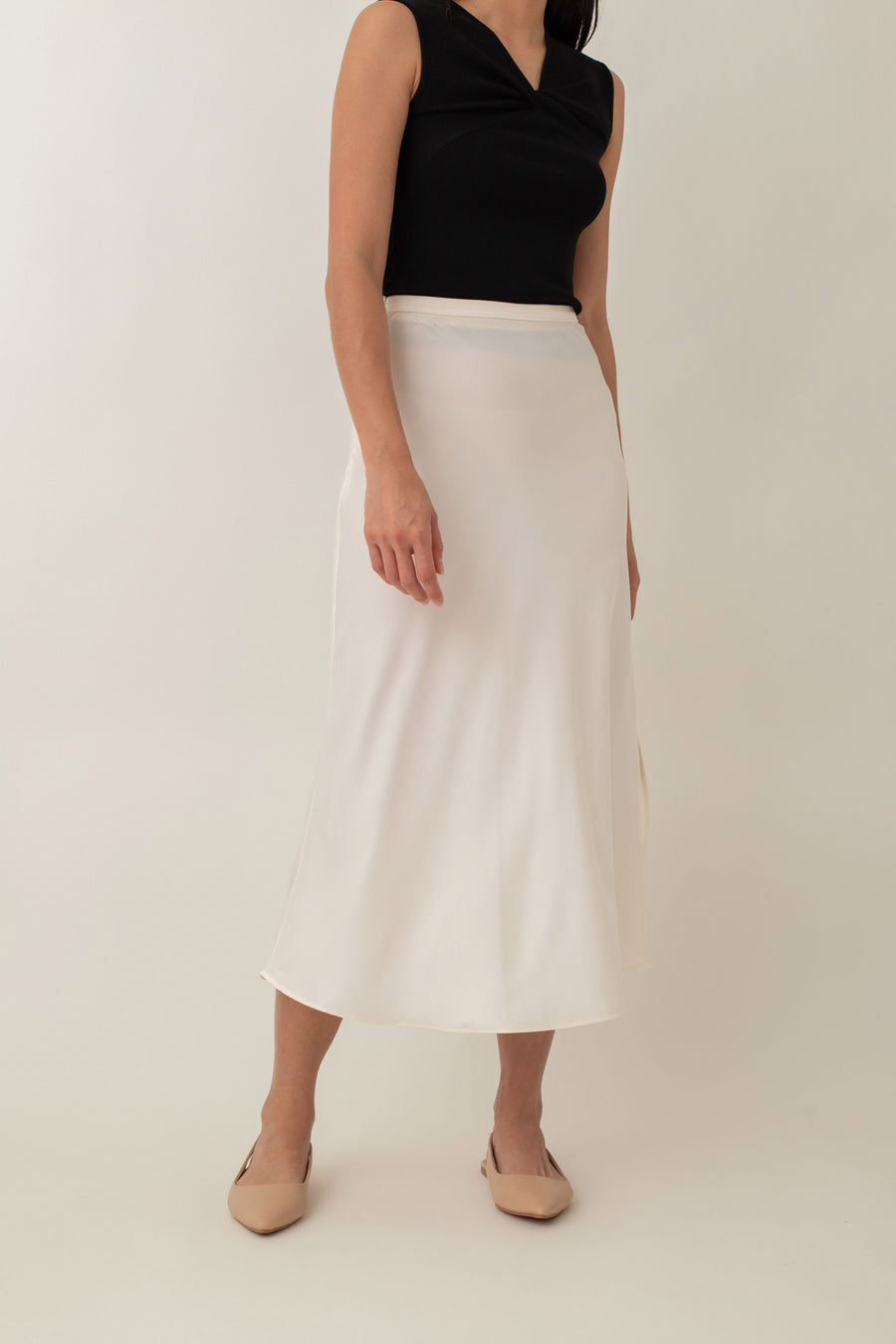 Crafted from silky fabric that feels smooth to the touch and features a subtle, beautiful sheen, the Thalia skirt flares gently from the waist. This design creates a flattering, flowy silhouette that moves gracefully with you.