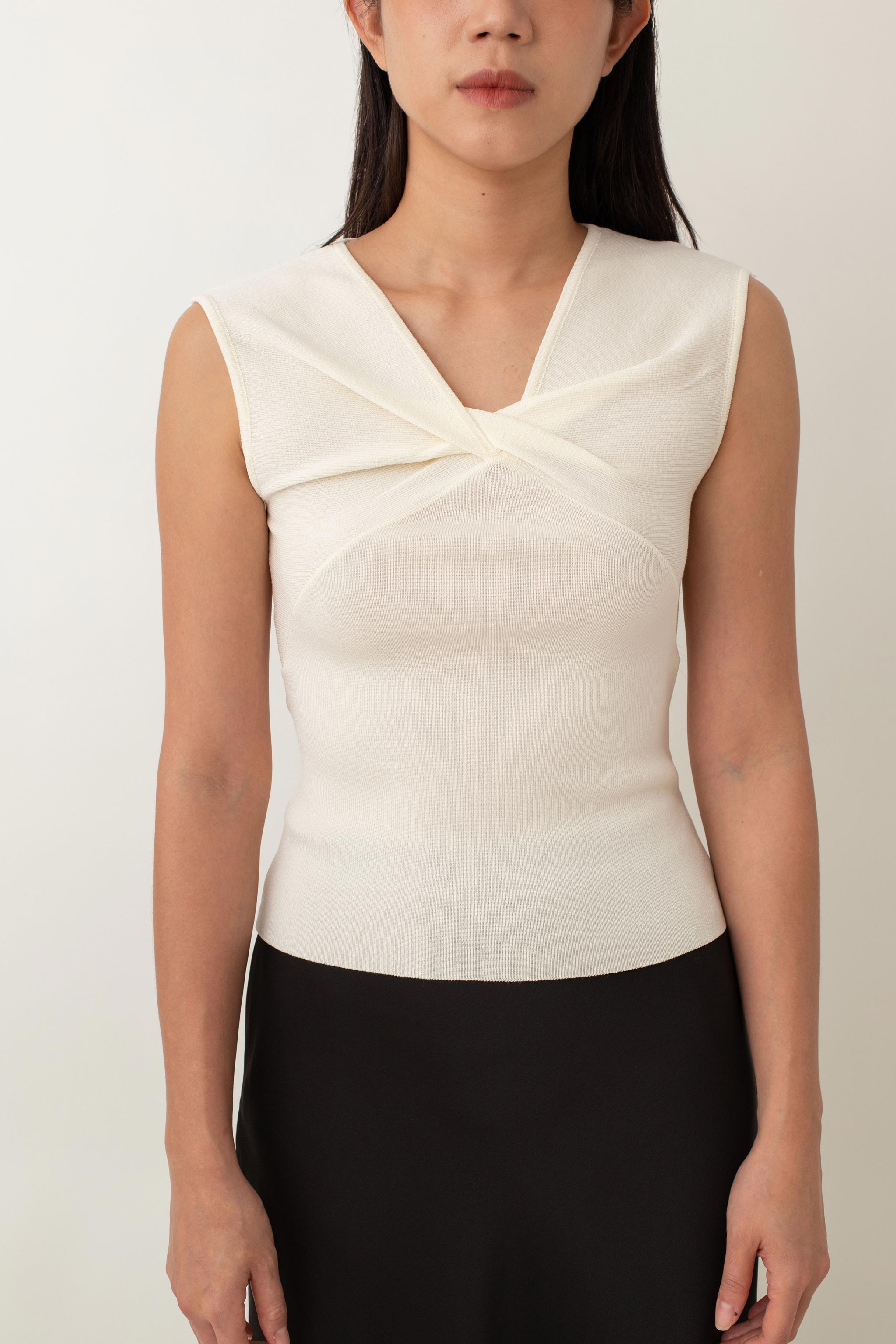 Crafted from a soft, stretchy fabric, Xanthe offers a comfortable fit that flatters your figure. The standout feature is the intricate knot detail at the front, adding a unique twist to a classic design. Pair it with high-waisted skirts or tailored pants for a chic, polished look, or dress it down with jeans for a stylish yet casual outfit.